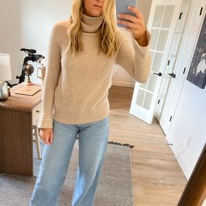 Tan turtleneck sweater with flared wrists. Size S.